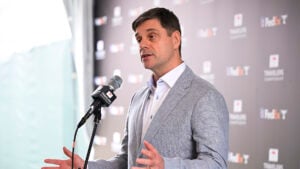 brian rolapp i grå kavaj bakom en mikrofon