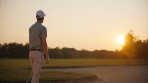 golfspelare på golfbana i solnedgång