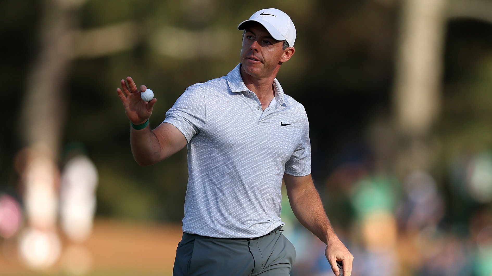 golfspelaren rory mcilroy tackar publiken med en golfboll i handen