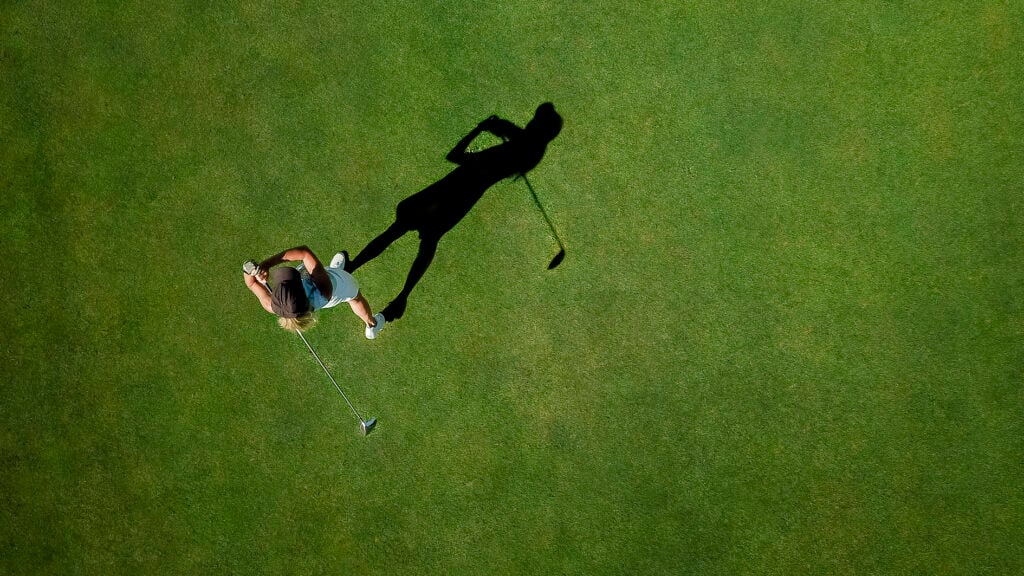 Woman playing golf on golf course