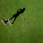 Woman playing golf on golf course