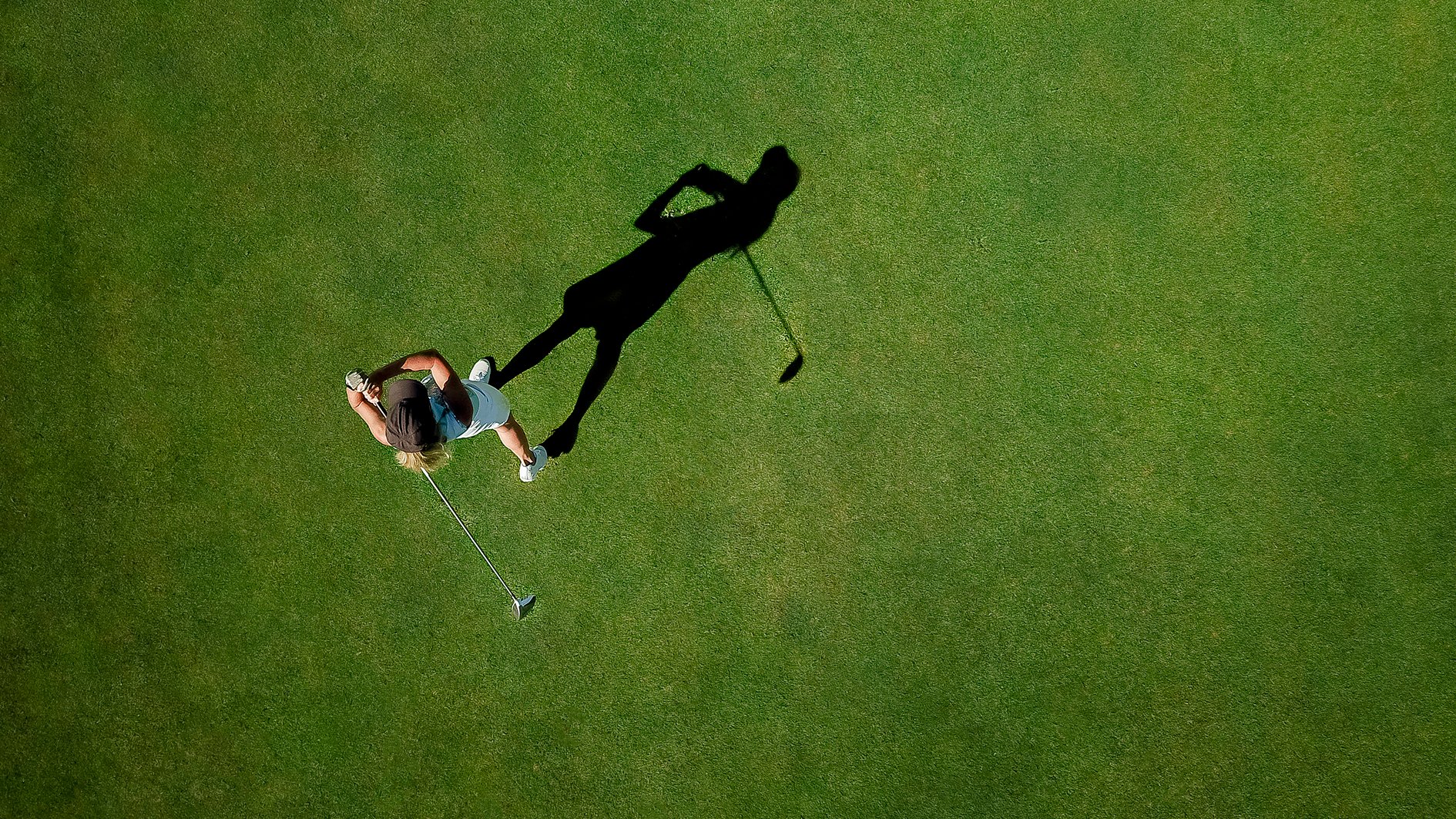 Woman playing golf on golf course