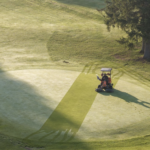 åkgräsklippare klipper green i dagg på golfbana i sverige