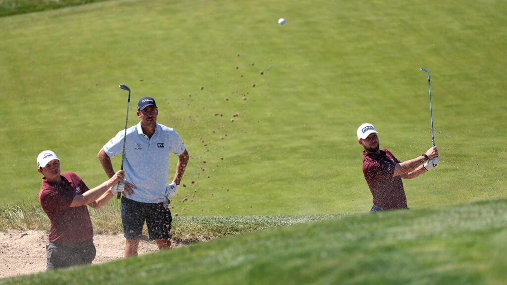 golfspelare övar bunkerslag på golfbana
