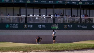 golfspelar och caddie på golfbana i saudiarabien