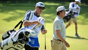 caddie och golfspelare på golfbana