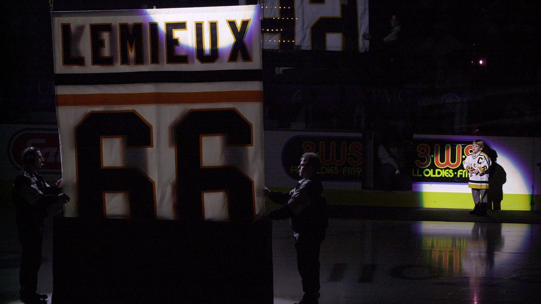 Austin Lemieux tittar på när pappa Mario Lemieuxs tröja hissas ner
